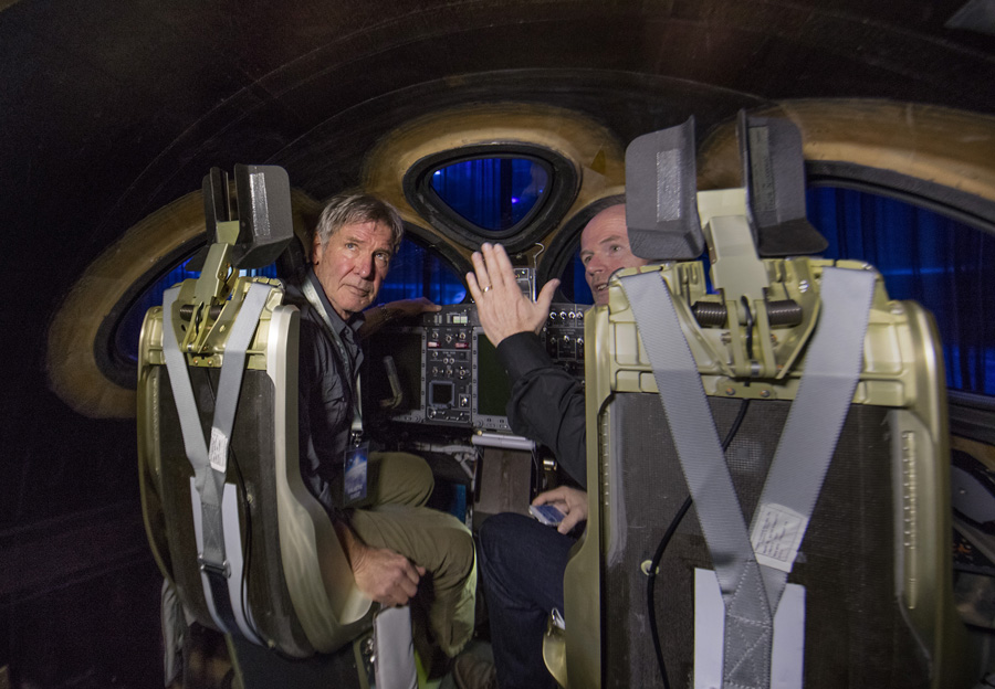 Actor and Pilot Harrison Ford listens to Virgin Galactic chief pilot Dave Mackay inside the new SS2.Virgin Spaceship Unity is unveiled in Mojave, California, Friday February 19th, 2016. VSS Unity is the first vehicle to be manufactured by The Spaceship Company, Virgin Galactic's wholly owned manufacturing arm, and is the second vehicle of its design ever constructed. VSS Unity was unveiled in FAITH (Final Assembly Integration Test Hangar), the Mojave-based home of manufacturing and testing for Virgin Galactic’s human space flight program. VSS Unity featured a new silver and white livery and was guided into position by one of the company’s support Range Rovers, provided by its exclusive automotive partner Jaguar Land Rover.